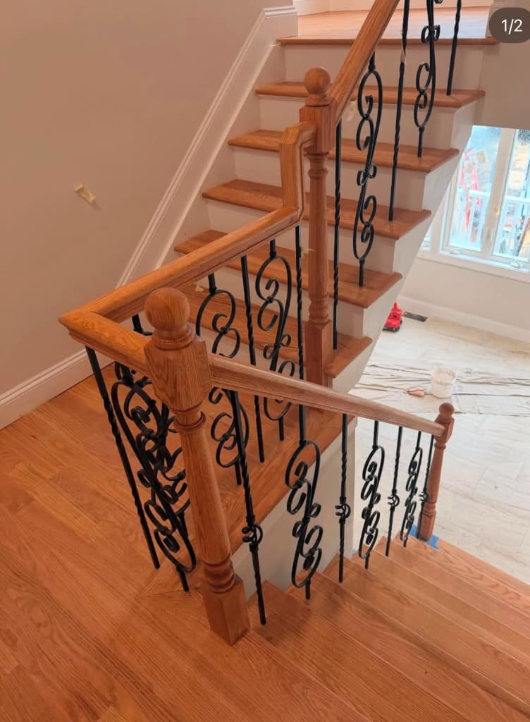 Elegant staircase handrail with ornamental iron spindles
